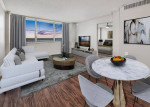 Modern living room with upgraded appliances and stylish furnishings at The Indigo Apartments in Clearwater, FL.