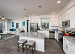 Stylish kitchen in Cape Coral apartments featuring granite countertops and stainless steel appliances.
