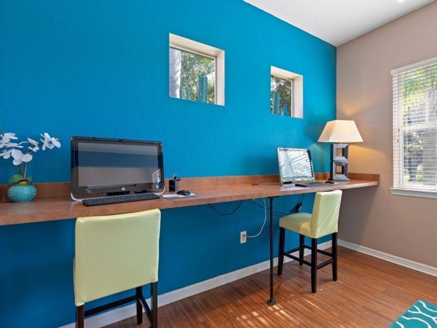 Modern business center with computer stations in a bright apartment community in Kissimmee, FL