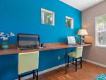 Modern business center with computer stations in a bright apartment community in Kissimmee, FL