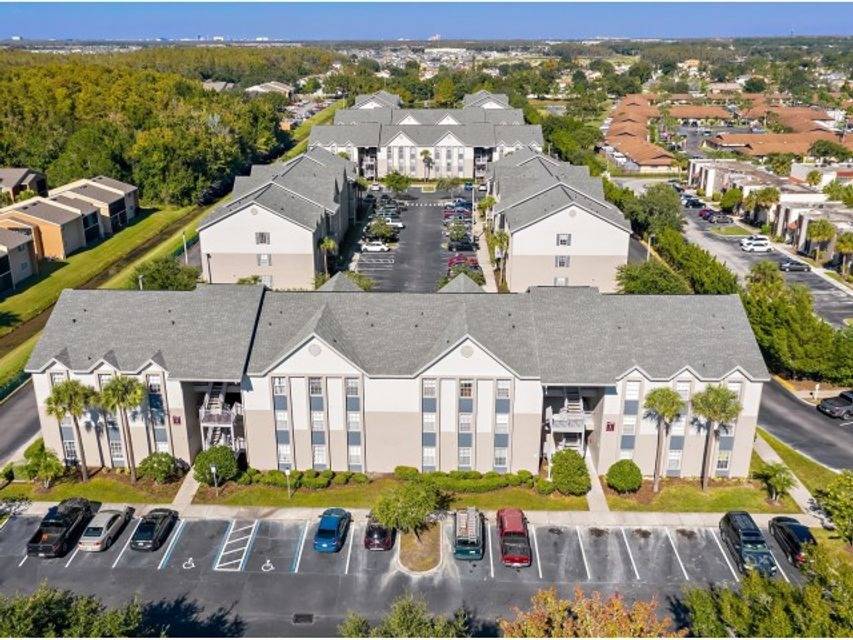 Aerial view of Miramar Apartments in Kissimmee, FL, showcasing 5-bedroom units and outdoor living spaces.