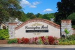 Carrington Park entrance sign with vibrant flowers, showcasing luxury apartment living near Atlanta.