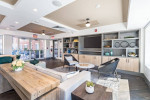Stylish clubhouse interior with seating, TV, and modern decor at Sofi apartments in Stamford