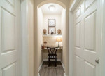 Cozy hallway desk space in Rose Heights Apartments with decorative items and warm lighting.