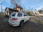 2012 GMC Acadia Denali FWD parked outside, featuring premium wheels and dual sun roofs.