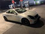06 Infiniti G35 Coupe parked at a gas station, featuring custom wheels and a sporty design.