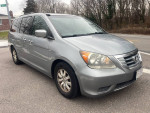 2009 Honda Odyssey EXL minivan with auto sliding door parked by the road, in excellent mechanical condition.