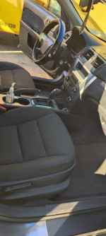 Interior view of a 2010 Ford Fusion, featuring black upholstery and modern dashboard design.