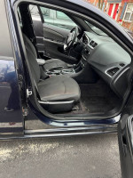 Interior view of a 2012 Dodge Avenger SXT showcasing front and back seats, well-maintained but needing repairs.