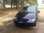2000 Dodge Caravan in blue color parked on a driveway, showing exterior features like roof rack and tires.