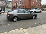 2017 Toyota Corolla LE parked on the street, showcasing a clean exterior and alloy wheels.