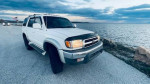 2002 Toyota 4Runner SR5 parked near water, showcasing its well-maintained exterior and scenic backdrop.