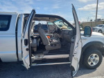 Interior view of a 2005 Ford F-250 Diesel Lariat with open doors, showing clean seating and dashboard details.