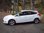 2013 Ford Focus SE Hatchback parked on a scenic road, showcasing its clean exterior and sleek design.