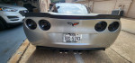 2006 Chevrolet Corvette C6 Z51 with rebuilt title and custom exhaust in a residential garage