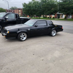 1985 Buick Grand National, black, with upgraded suspension and custom downpipe parked on the street
