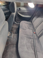 Clean interior of a 2005 Dodge Stratus sedan with rear seats and vacuum cleaner