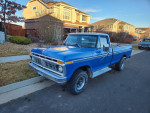1977 Ford F150 4x4 Pickup truck in blue parked on the street, showcasing its classic design and robust build.