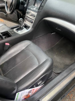 Interior view of a 2009 Infiniti G37 with black leather seats and modern dashboard controls.