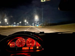 Interior view of 2002 BMW 3 Series 330xi during night drive, showcasing dashboard and headlights.