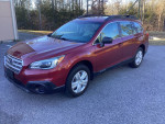 2016 Subaru Outback in red, showcasing low mileage, all-wheel drive, and well-maintained features.