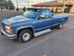 1991 Chevy Silverado C1500 pickup truck in blue parked in an empty lot, featuring clean exterior and 8-foot bed.