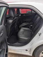 Interior view of a 2014 Chrysler 300 with leather seats, showcasing the backseat space and details.