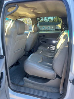 Interior view of a 2003 Chevrolet Silverado 1500 showing spacious leather seating in good condition.