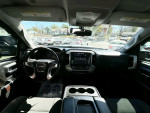 Interior view of a GMC Sierra with a modern dashboard and grey cloth seats.