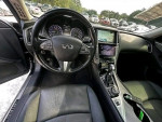 Interior view of a black Infiniti Q50 sedan, showcasing dashboard, steering wheel, and touchscreen features.
