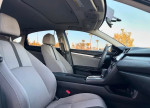 Interior view of a Honda Civic featuring comfortable seats, modern dashboard with backup camera and moonroof.