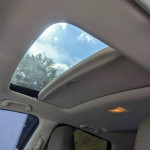 Interior view of Honda CR-V sunroof with clear sky and sunlight shining through