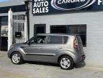 2010 Kia Soul wagon in Titanium color showcasing fuel efficiency and a clean title at an auto sales location.