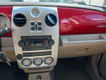 Interior dashboard of a 2006 Chrysler PT Cruiser Touring Wagon with red accents and stereo controls.