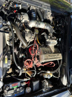 1994 Ford Mustang Cobra engine bay with supercharger and performance upgrades, showcasing powerful performance features.