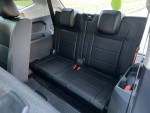 Back seat interior of a 2018 Volkswagen Tiguan S, showcasing clean black leather seats and spacious design.