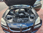 Open hood of a 2014 BMW 6 Series 640i convertible showing engine and components