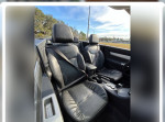 Interior view of a 2010 Chrysler Sebring Limited showing leather seats and console.