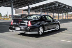 2001 Chevrolet Monte Carlo LS parked in a sunny outdoor area with modern architecture in the background