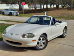 1999 Mazda MX-5 Miata Touring Package parked, features power windows and responsive handling, great for driving enthusiasts.