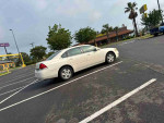 2012 Chevrolet Impala LS parked in lot, offering spacious interior and reliable performance with 182,357 miles.