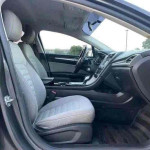 Interior view of a 2015 Ford Fusion with clean seats and modern dashboard features.