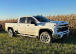2024 Chevrolet Silverado 2500HD work truck parked in a field, available for delivery, in good condition.