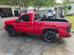 2007 Chevrolet Silverado 1500 Classic LT1 in red, parked with black wheels, showcasing its sleek regular cab design.