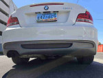 Rear view of a 2013 BMW 1 Series 128i showcasing sleek design and sporty exhaust.