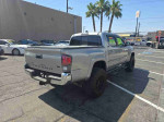 Silver 2016 Toyota Tacoma Double Cab for sale in North Las Vegas, showcasing rear view with clean title.