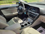 Interior view of 2016 Nissan Maxima 3.5 SR with automatic transmission and beige upholstery.