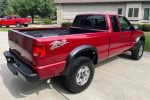 Red 2003 Chevrolet S-10 LS ZR2 extended cab truck parked in driveway with clean exterior and good tires.