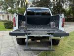 2013 Ford F-150 FX4 truck with a drop-down tailgate and bed liner in a residential area