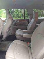 Interior of a 2012 Buick Enclave SUV featuring leather seats and spacious seating for seven passengers.